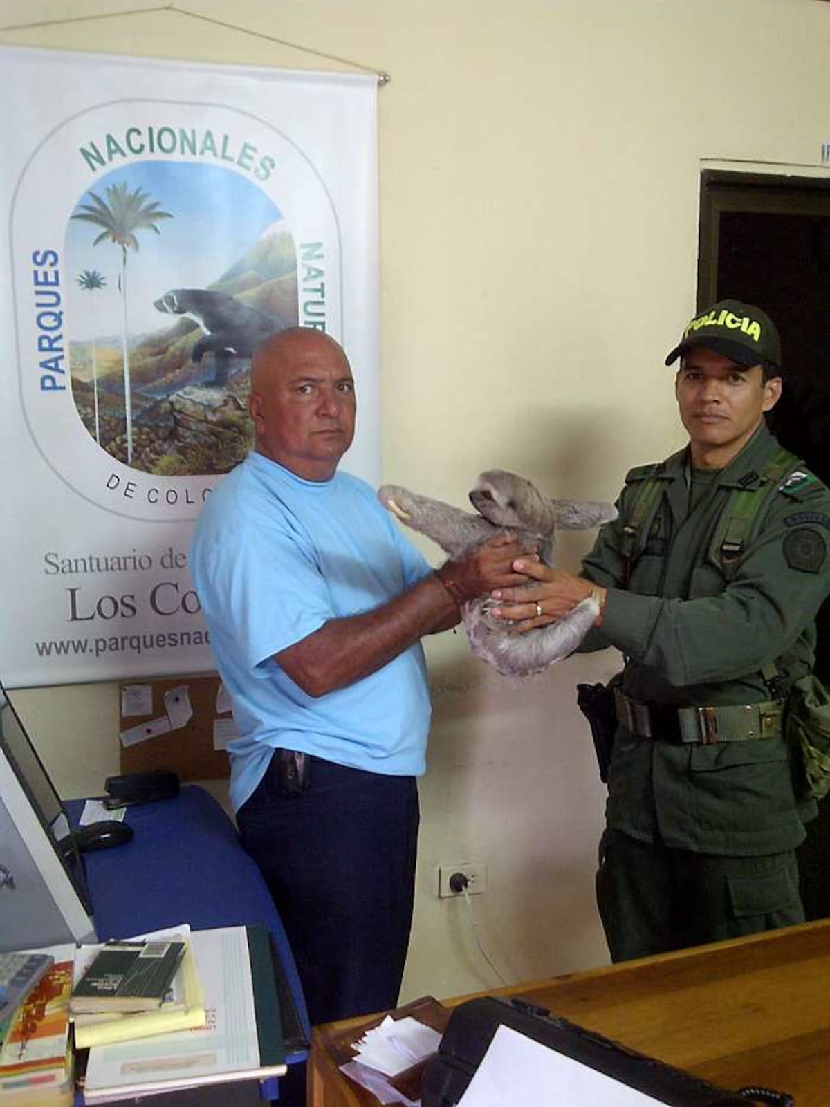 Franklin Soto Ramos, coordinador de la Policía comunitaria entrega el oso perezoso al administrador del Santuario Los Colorados, Tito Rodríguez. LILA LEYVA VILLARREAL, CORRESPONSAL EL UNIVERSAL