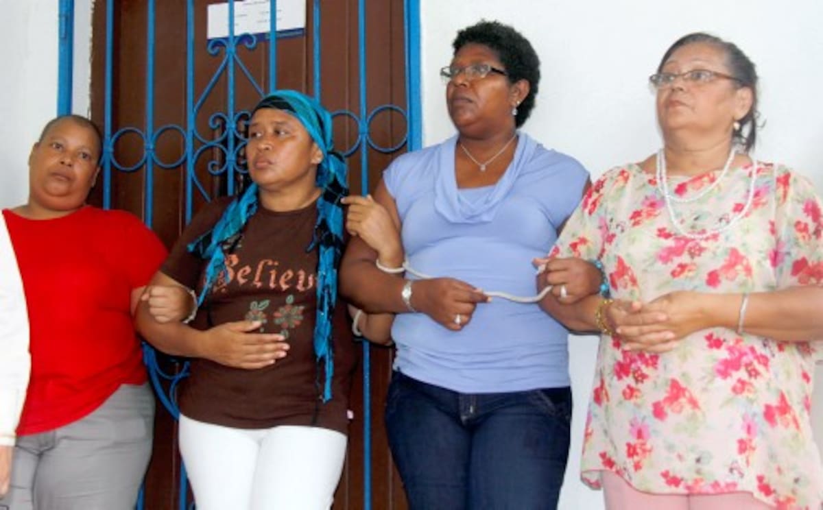 Edith Revolledo, Candelaria Domínguez, Carmen Ramírez y Muriel Ramos se ataron frente a la sede de Humana Vivir y con carteleras reclamaron: ¡No jueguen con nuestra vida! KAILLINE GIRALDO – EL UNIVERSAL