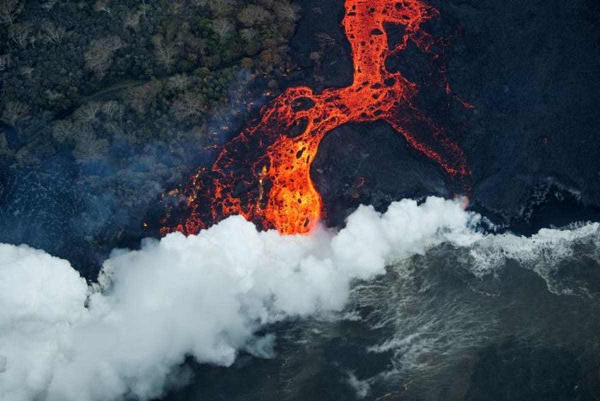 Las llamas azules por el consumo de gas metano son el más reciente fenómeno natural que despliega la erupción del volcán Kilauea en Hawai. EFE BRUCE OMORI/PARADISE HELICOPTER