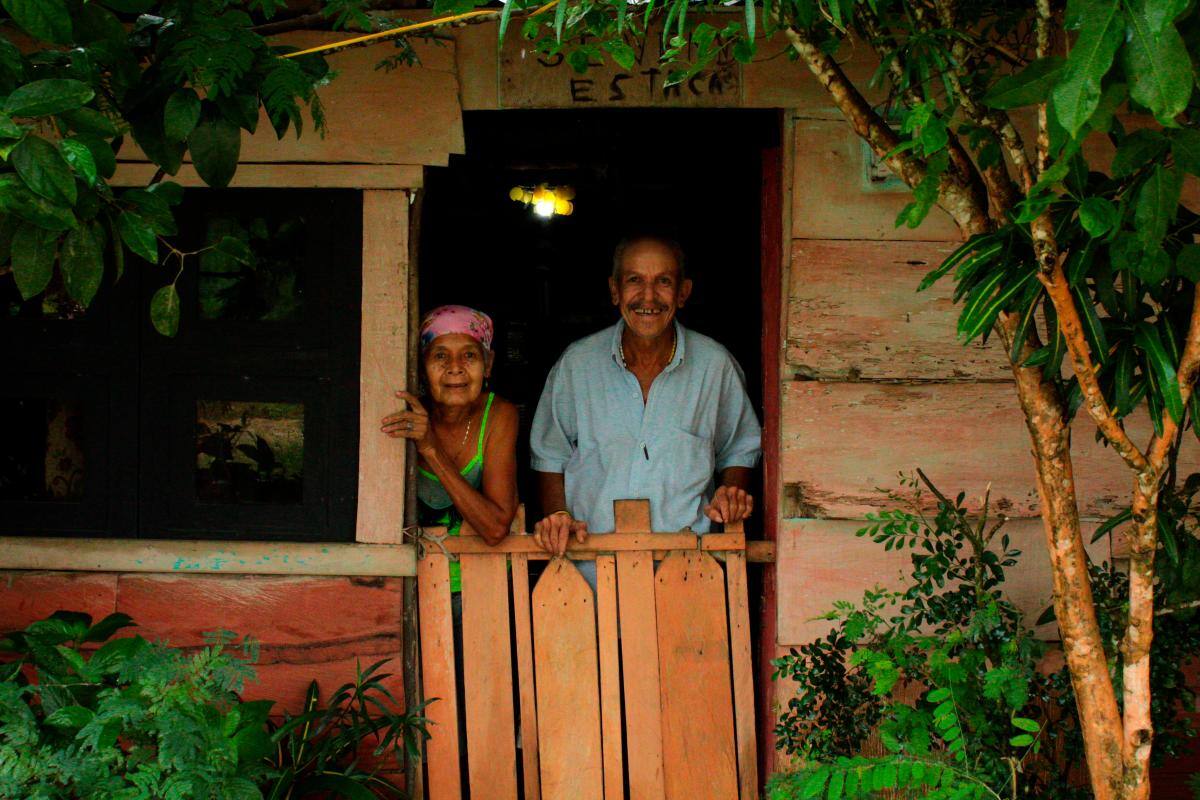 Una pareja de ancianos posa frente al lente de uno de los expositores de Unibac.