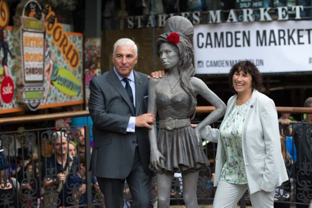 Mitch Winehouse y Janis Winehouse junto a la estatua hecha en homenaje de su hija Amy. AP Tim Ireland
