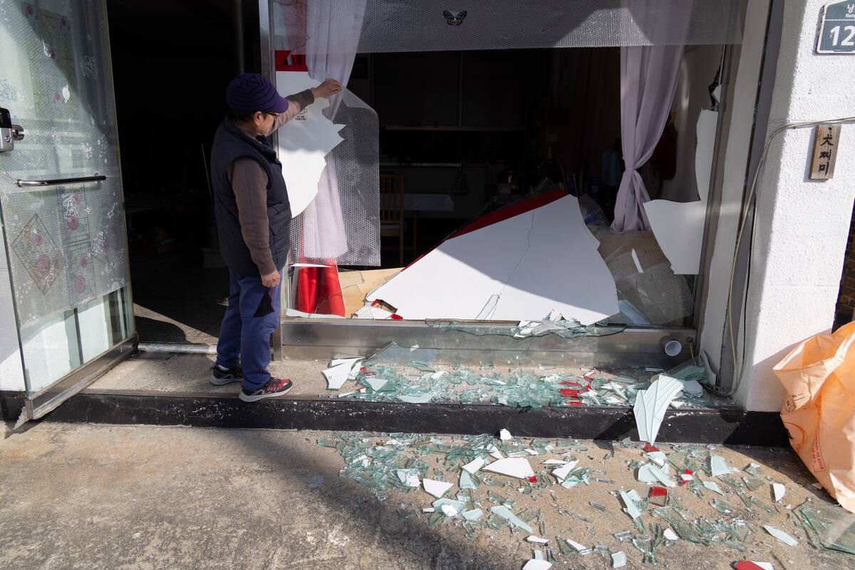 Una residente mira su casa con las ventanas rotas en un pueblo, lugar del bombardeo accidental de un avión de combate, en Pocheon, Corea del Sur. //EFE