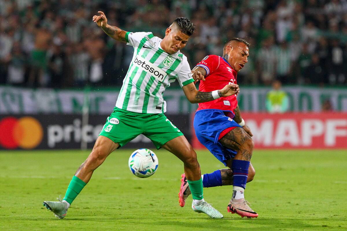 AMDEP4726. MEDELLÍN (COLOMBIA), 02/04/2025.- Jorman Campuzano (i) de Atlético Nacional disputa un balón con Eduardo Vargas de Nacional este miércoles, en un partido de la fase de grupos de la Copa Libertadores entre Atlético Nacional y Nacional de Uruguay en el estadioAtanasio Girardot en Medellín (Colombia). EFE/ STR