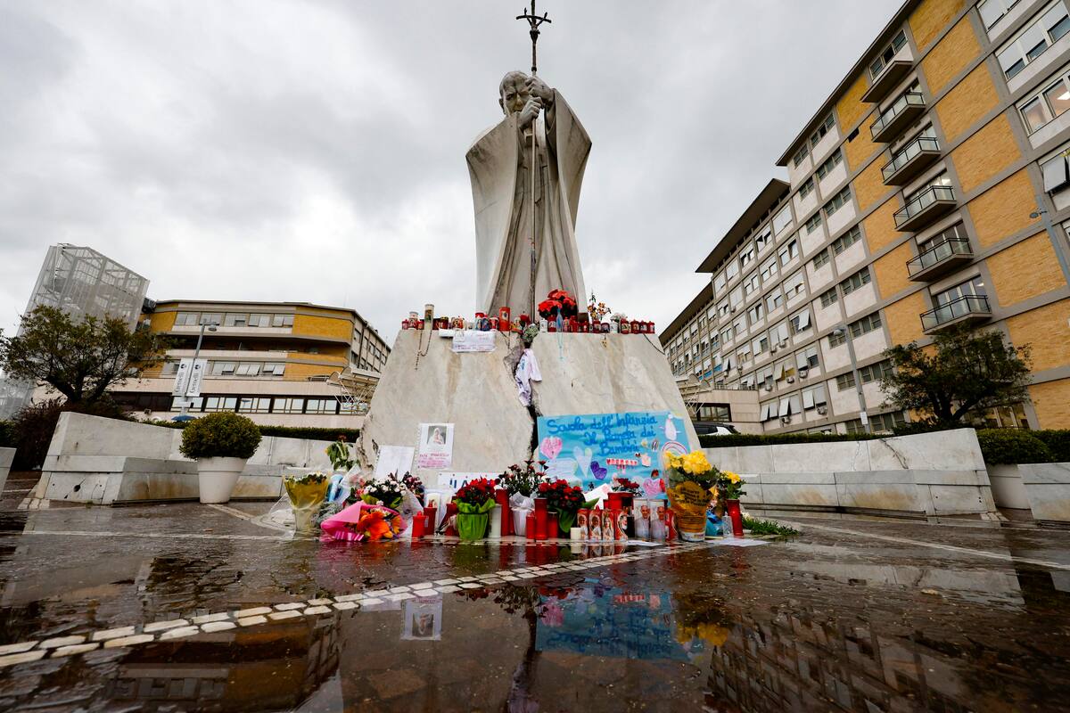 La estatua del papa Juan Pablo II en la entrada de la clínica Gemeli, donde el papa Francisco permanece hospitalizado. //EFE