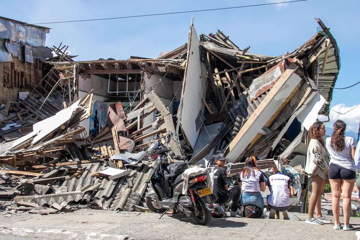 AME7780. MANIZALES (COLOMBIA), 10/08/2026.- Personas observan una edificación destruida por un terremoto de magnitud 7,4 este lunes, en Manizales (Colombia). El presidente de Colombia, Abelardo de la Espriella, afirmó que el terremoto que sacudió la mayor parte del país, deja una cifra parcial de 111 fallecidos y una gran destrucción en al menos cinco departamentos. EFE/ Juan Augusto Cardona
