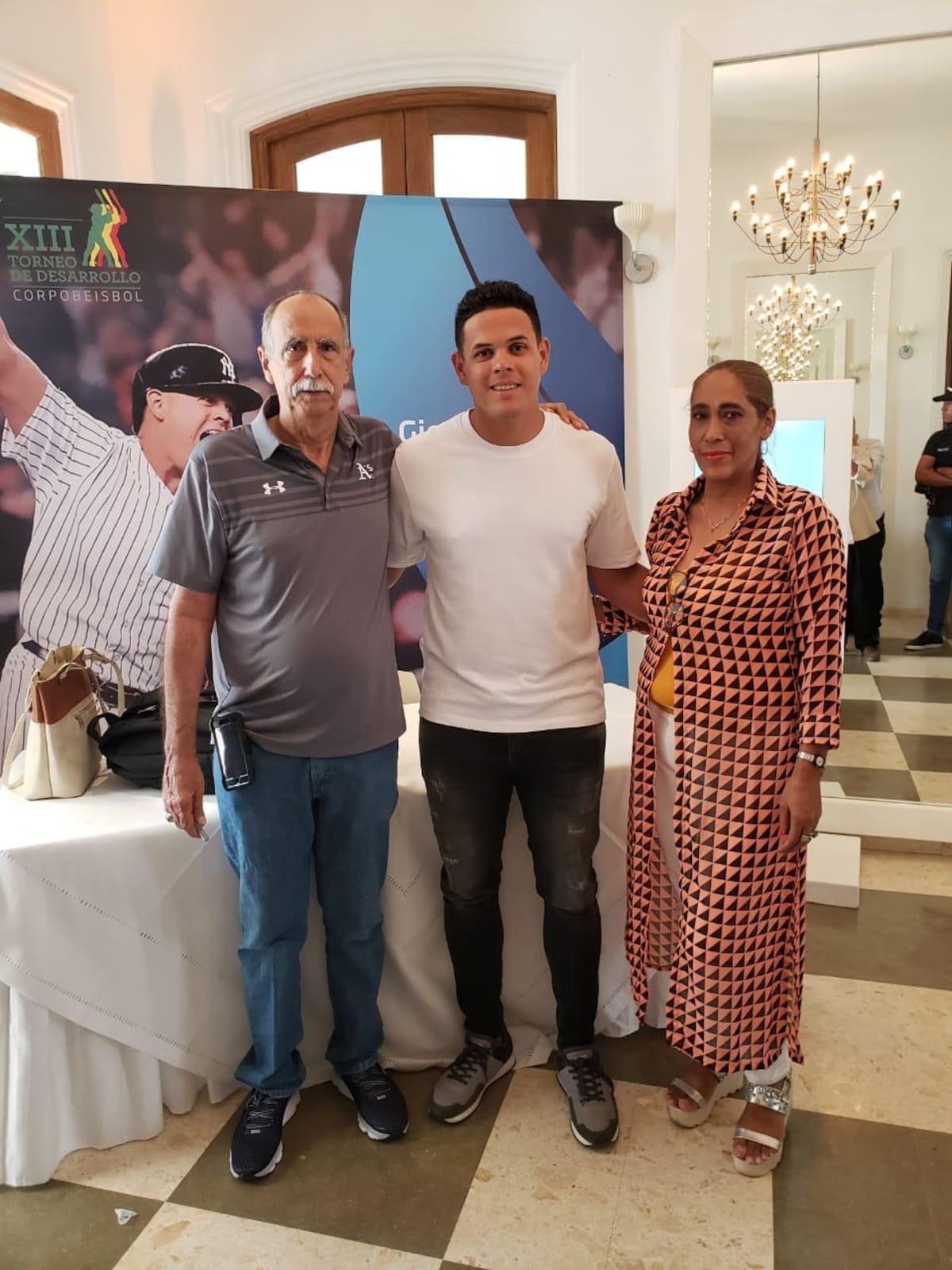 José 'Tito' Quintero (I) y su esposa Arelis Hernández (D) junto a Gio Urshela (C). //Cortesía