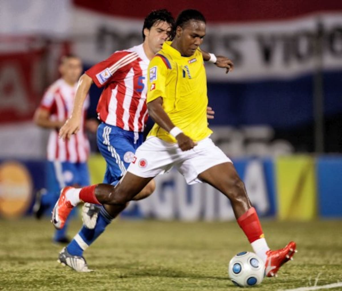 Colombia's Hugo Rodallega, front, scores during a 2010 World Cup qualifying game against Paraguay in Asuncion, Wednesday, Oct. 14, 2009. Colombia won 2-0. (AP Photo/Jorge Saenz)
