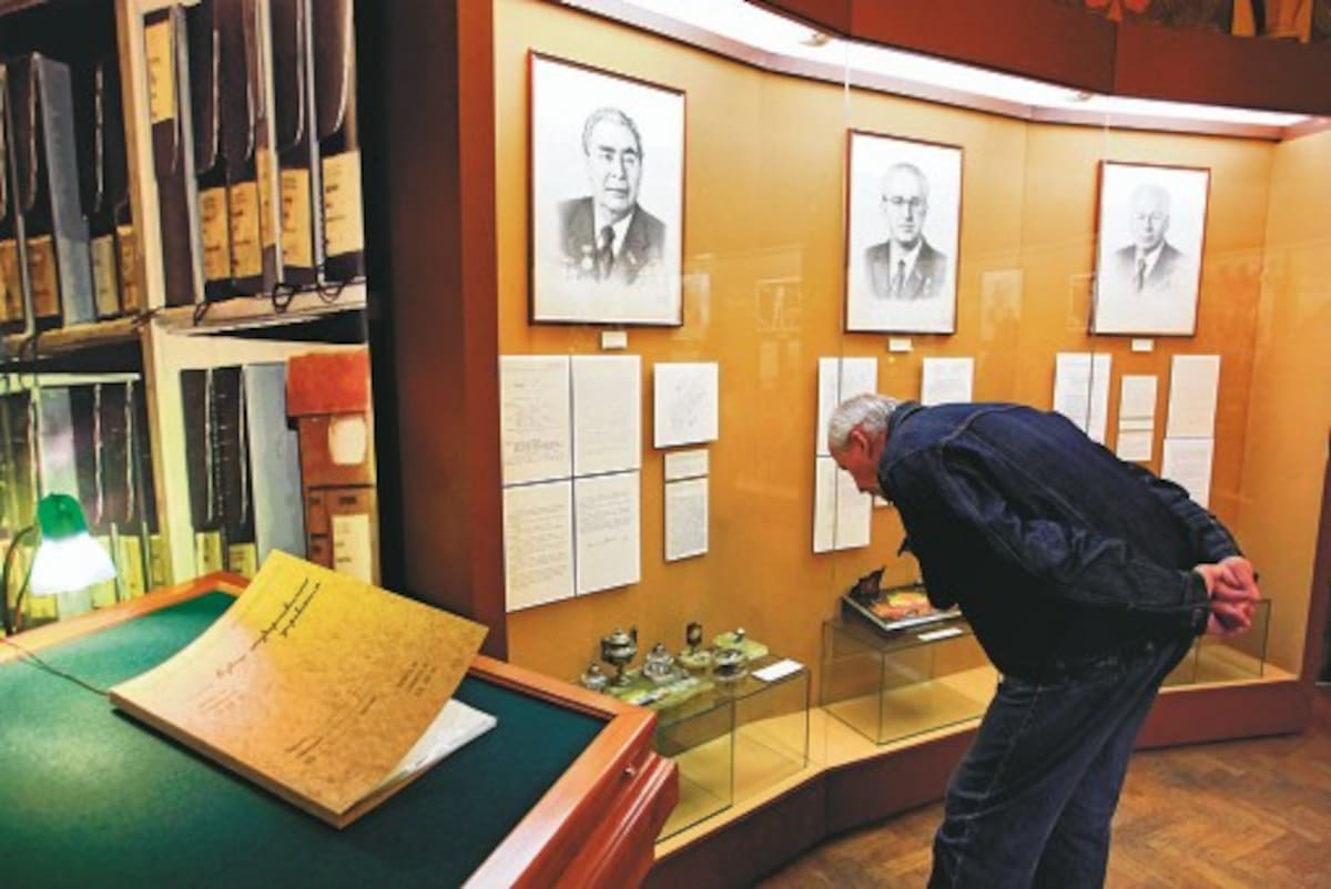 In this Wednesday, May 18, 2011 photo a visitor looks at documents on display at the exhibition in the State History Musum in Moscow, Russia. For the first time ever, ordinary Russians can now see documents that appear to confirm long-standing rumors that Vladimir Lenin had Jewish heritage. (AP Photo/Sergey Ponomarev)