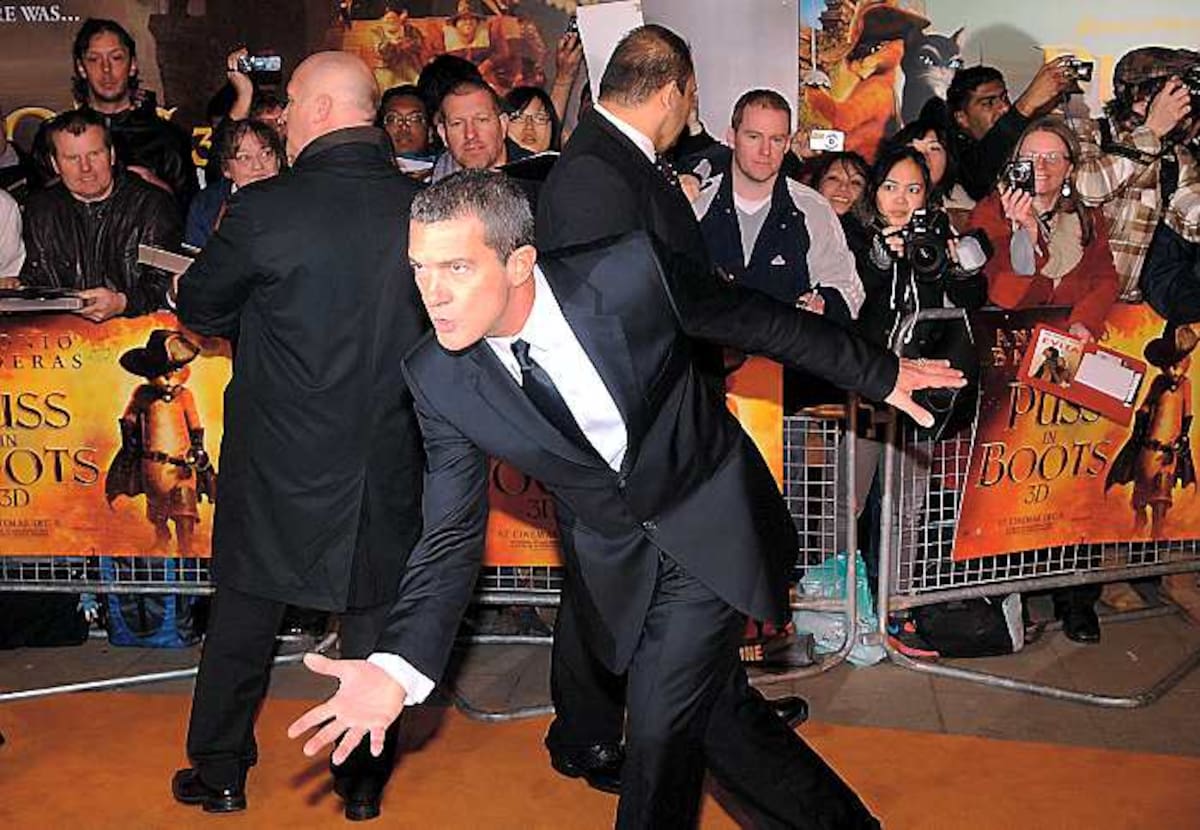 Spanish actor Antonio Banderas jokes around as he arrives for the Premiere of the film "Puss in Boots" in Leicester Square on November 24, 2011 in London. AFP PHOTO / Max Nash