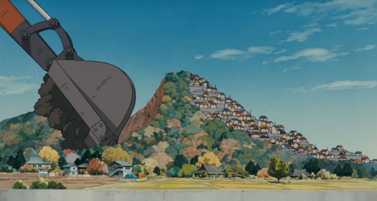 En esta metáfora visual, una retroexcavadora remueve las colinas de Tama para luego construir casas. //Foto: Captura de pantalla Netflix.